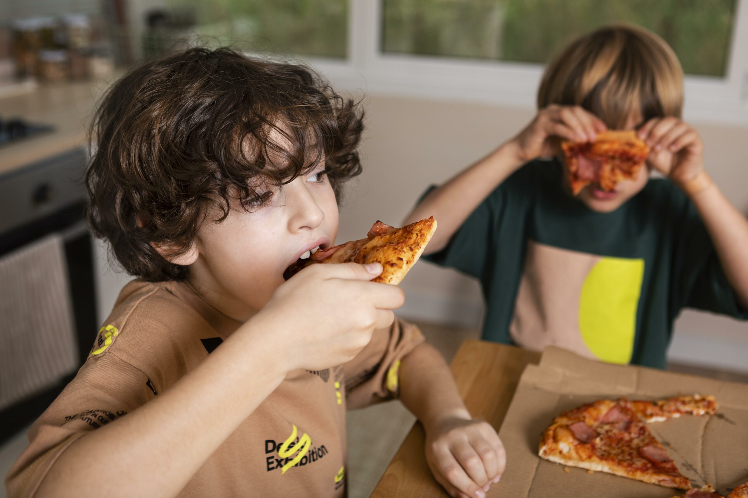 Kids Eating Pizzas Together Scaled